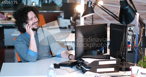 Image of businessman working using a computer in startup office