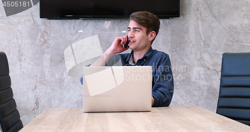 Image of businessman working using a laptop in startup office