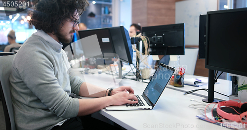 Image of businessman working using a laptop in startup office