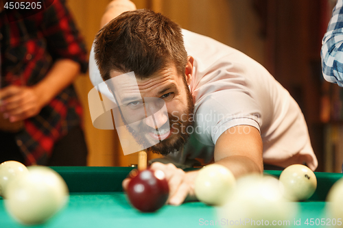 Image of Close-up shot of a man playing billiard