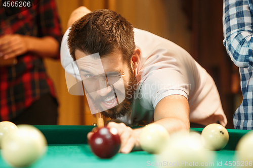 Image of Close-up shot of a man playing billiard