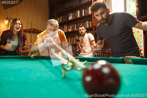 Image of Close-up shot of a man playing billiard