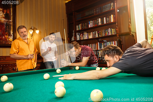 Image of Close-up shot of a man playing billiard