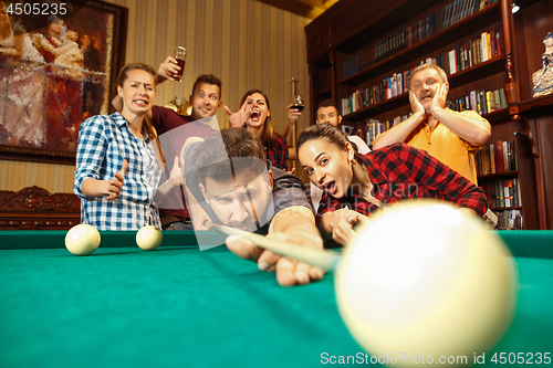 Image of Close-up shot of a man playing billiard