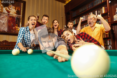 Image of Close-up shot of a man playing billiard