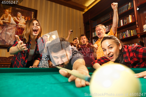 Image of Close-up shot of a man playing billiard