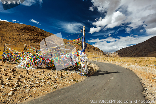 Image of Road and Buddhist prayer flags lungta at Namshang La pass. Lad
