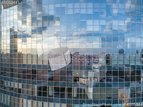 Image of Beautiful sunset reflecting in the windows facade of modern office business building.