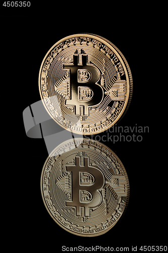 Image of Gold Bitcoin Coin on black background.