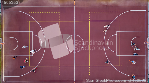 Image of Basketball court with players and ball. Sports game in basketball. View strictly from above with the drone.