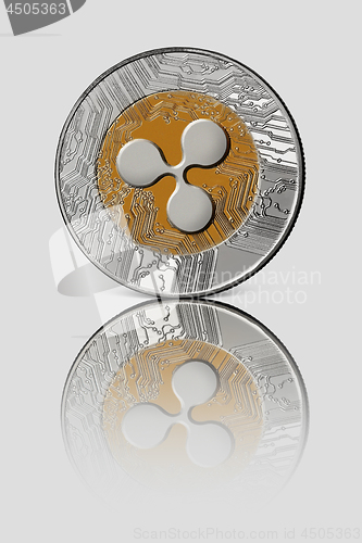 Image of Coin ripple on white glossy background. Conceptual image for worldwide cryptocurrency and digital payment system.