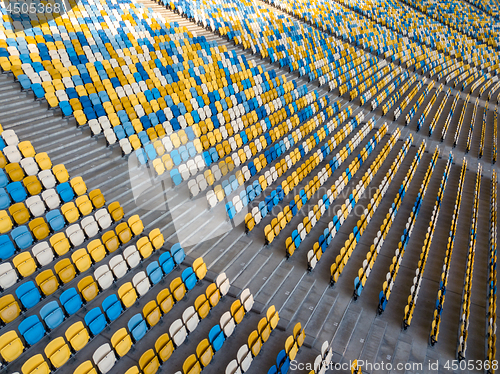 Image of KYIV, UKRAINE - July 19, 2018. Aerial view empty tribunes of NSC Olimpiysky before the game in blue and yellow colors