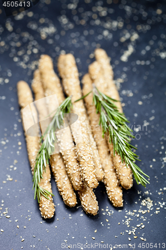 Image of Italian grissini or salted bread sticks with sesame and rosemary