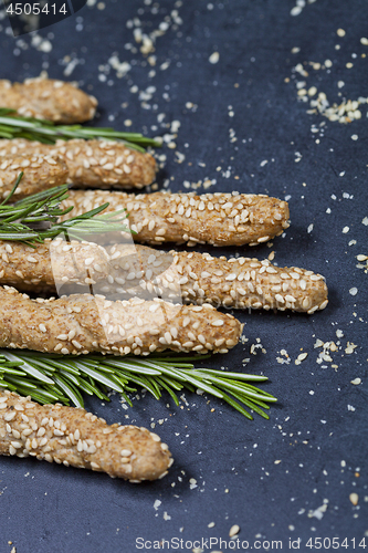 Image of Italian grissini or salted bread sticks with sesame and rosemary