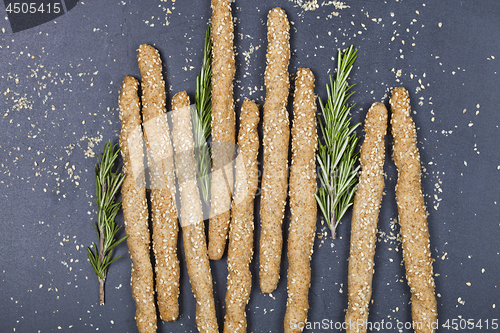 Image of Italian grissini or salted bread sticks with sesame and rosemary