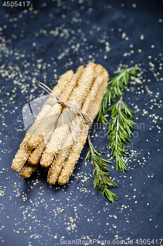 Image of Italian grissini or salted bread sticks with sesame and rosemary