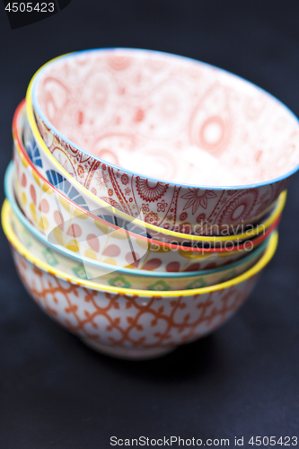 Image of Stack of colorful empty ceramic bowls closeup.