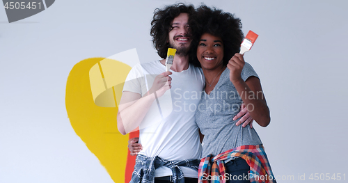 Image of couple with painted heart on wall