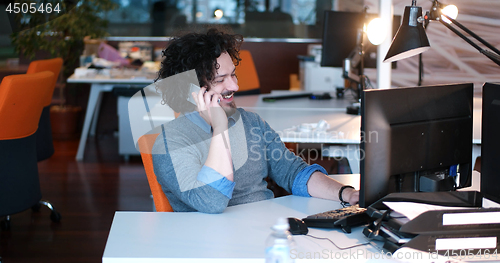 Image of businessman working using a computer in startup office