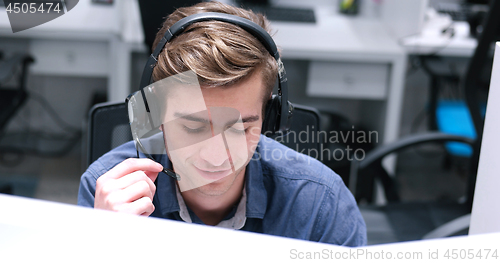 Image of male call centre operator doing his job