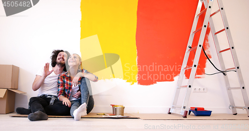 Image of Happy young couple relaxing after painting