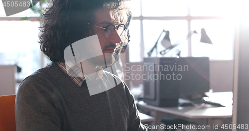 Image of businessman working using a computer in startup office
