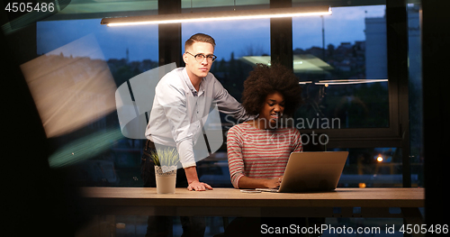 Image of Multiethnic startup business team in night office