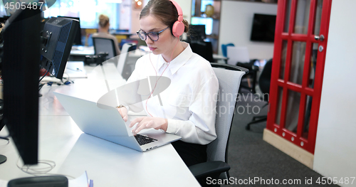 Image of businesswoman using a laptop in startup office