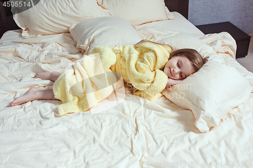 Image of The child little girl sleeping in the bed