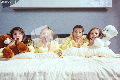 Image of The group of friends taking goog time on bed