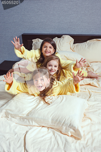 Image of The group of girlfriends taking goog time on bed