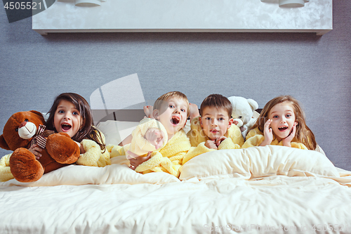 Image of The group of friends taking goog time on bed