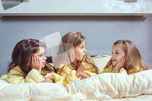 Image of The group of girlfriends taking goog time on bed