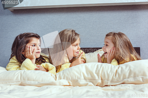 Image of The group of girlfriends taking goog time on bed