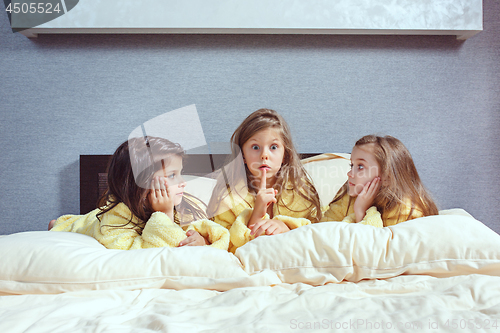 Image of The group of girlfriends taking goog time on bed