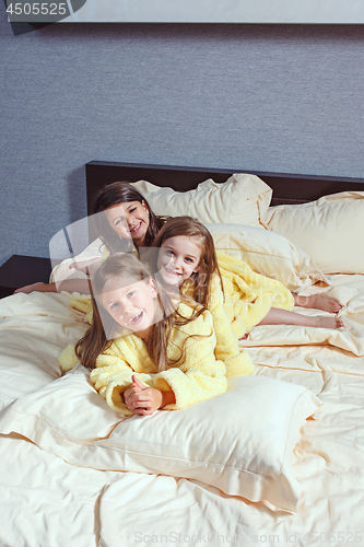 Image of The group of girlfriends taking goog time on bed