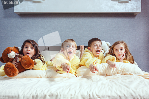 Image of The group of friends taking goog time on bed