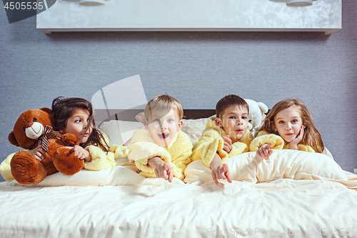 Image of The group of friends taking goog time on bed