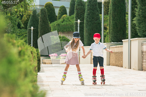 Image of Portrait of a charming teenage couple roller-skating together