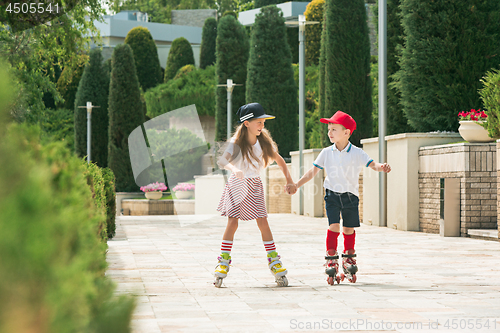 Image of Portrait of a charming teenage couple roller-skating together