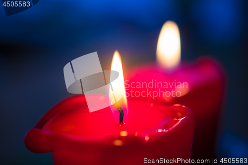 Image of Two red burning candels 