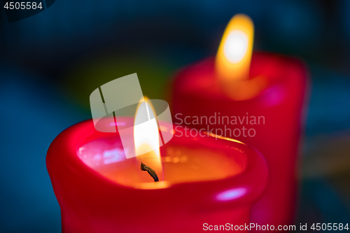 Image of Two red burning candels 