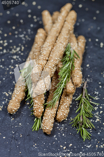 Image of Italian grissini or salted bread sticks with sesame and rosemary