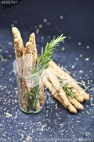 Image of Italian grissini or salted bread sticks with sesame and rosemary