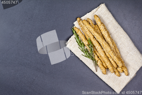 Image of Italian grissini or salted bread sticks with sesame and rosemary