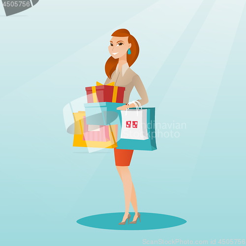 Image of Woman holding shopping bags and gift boxes.