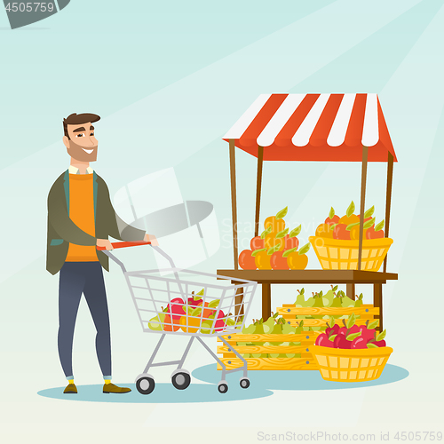 Image of Young caucasian man pushing a supermarket cart.