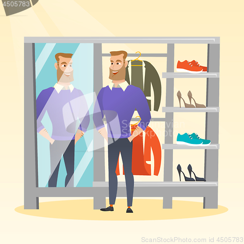 Image of Caucasian man trying on sweater in a dressing room
