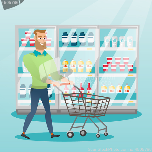 Image of Young caucasian man with supermarket trolley.