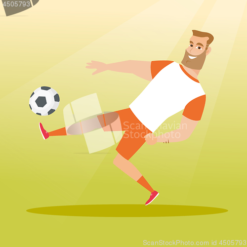 Image of Young caucasian soccer player kicking a ball.